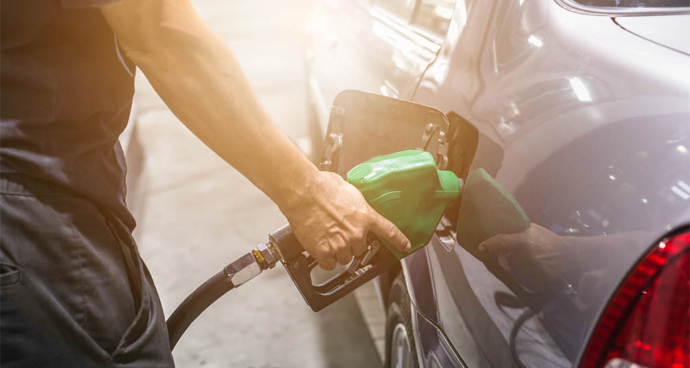 man pumping fuel into his car