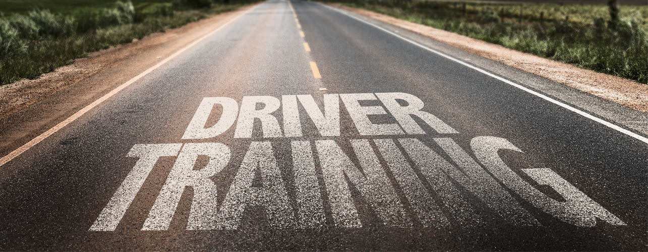 a road with the text "driver training" written onto it