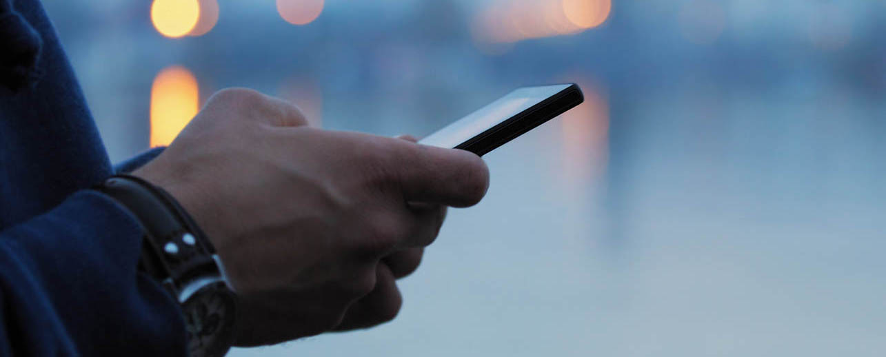 a man using mobile forms application on a smartphone to reduce paper costs