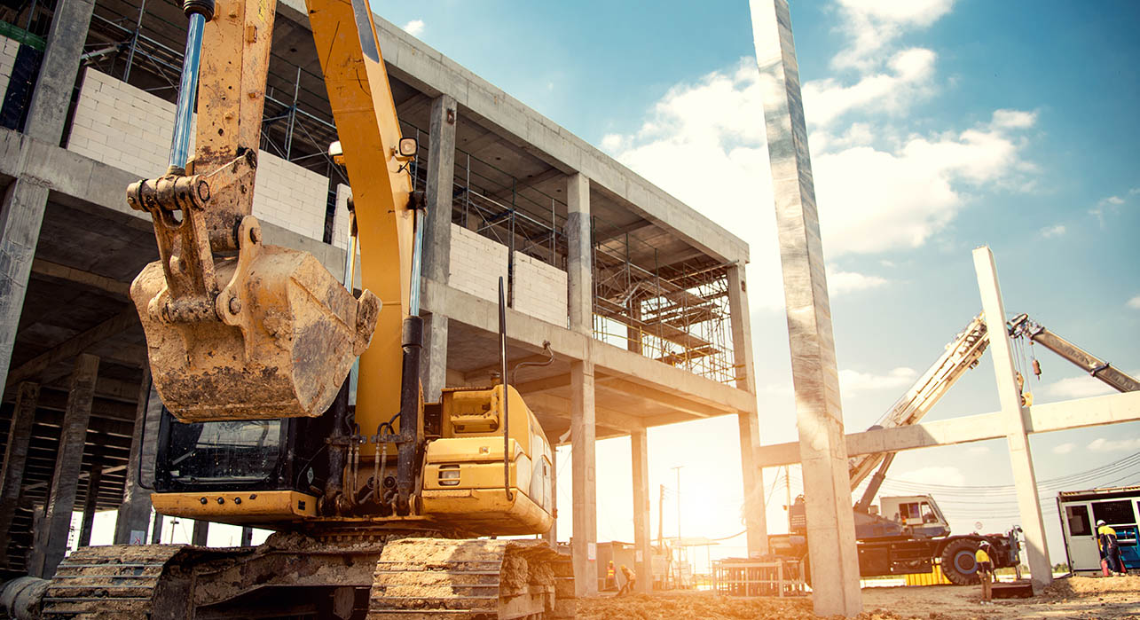 a digger and construction fleet on a construction site