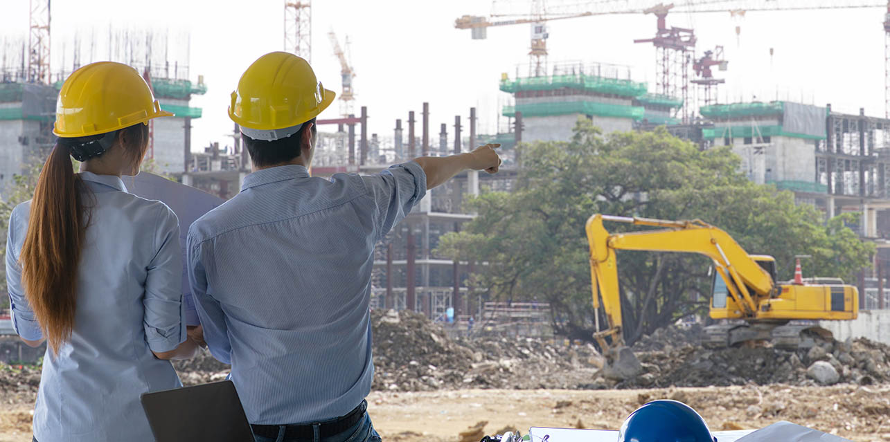 construction fleet managers overlooking a project
