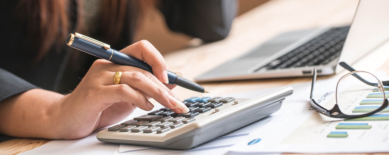 a lady using a calculator to figure out fleet management costs