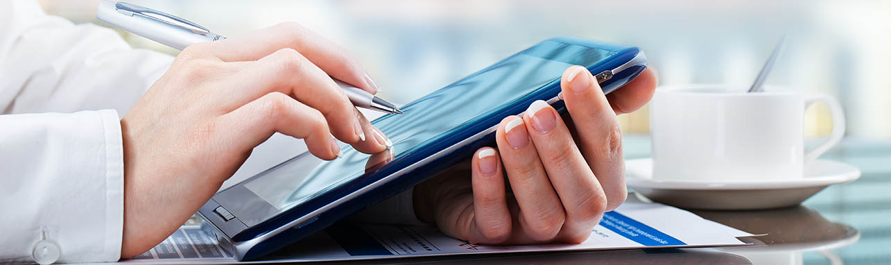 a woman using a tablet to overcome asset management challenges