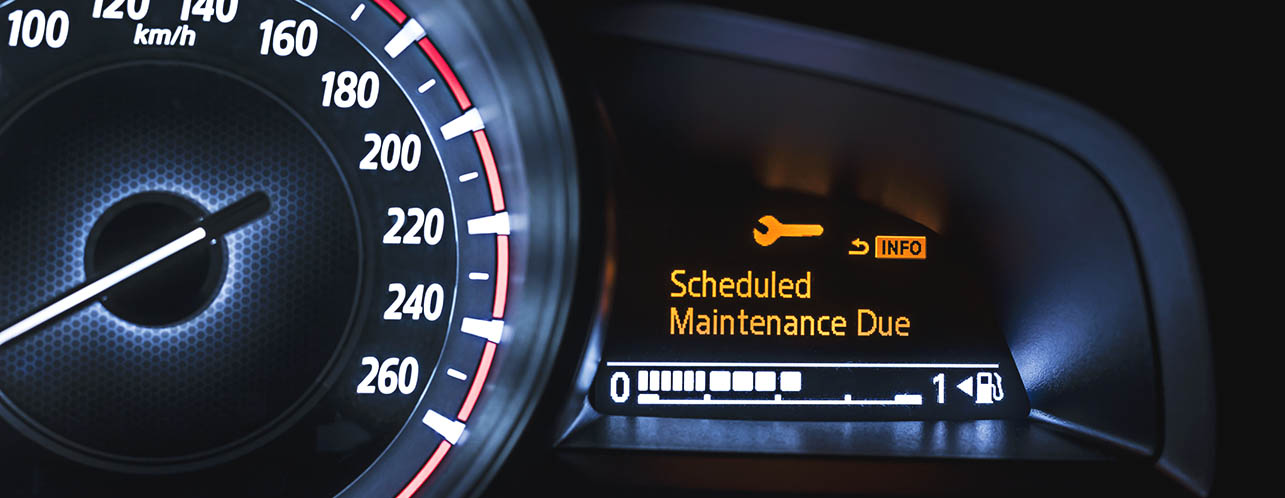 a dashboard that shows a speedometer and also has a messaged alerting the driver that the fleet vehicle is due for scheduled maintenance