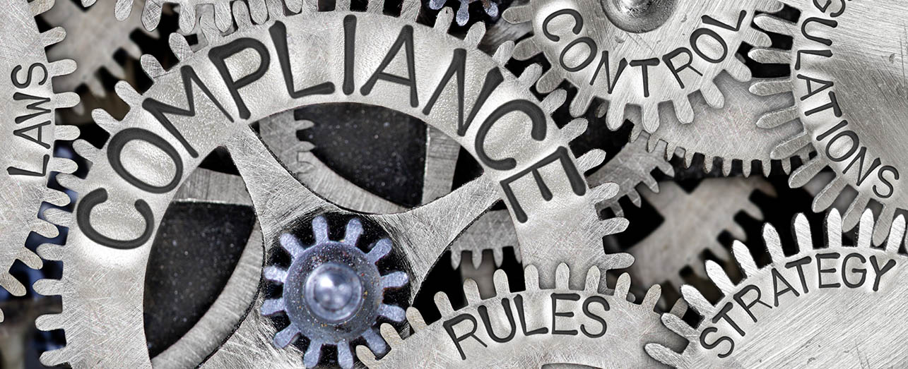 cogs with words written on them - "laws", "compliance", "control", "rules", "strategy" and "regulations"