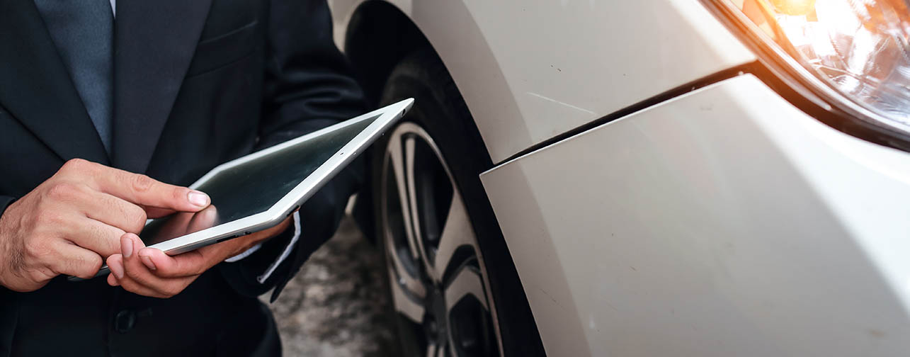 a man using a tablet to report vehicle downtime